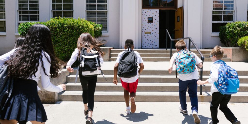 kids running back into school
