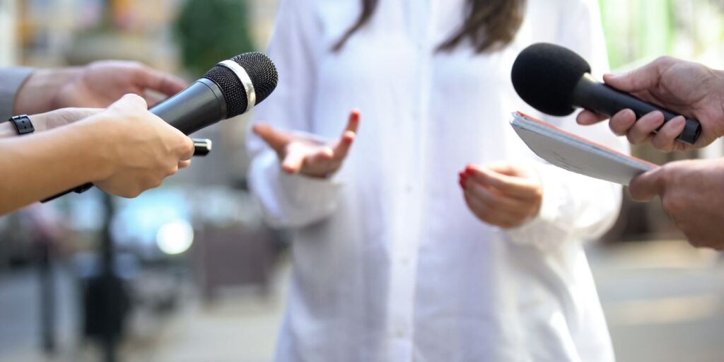 woman with microphones held up to have her say